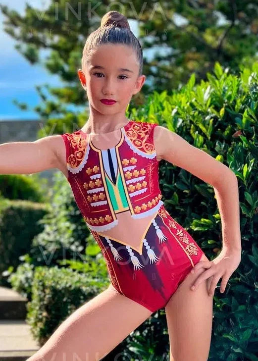Body da ginnastica ritmica ispirato al traje de luces con dettagli in passamaneria dorata e nappe stampate.