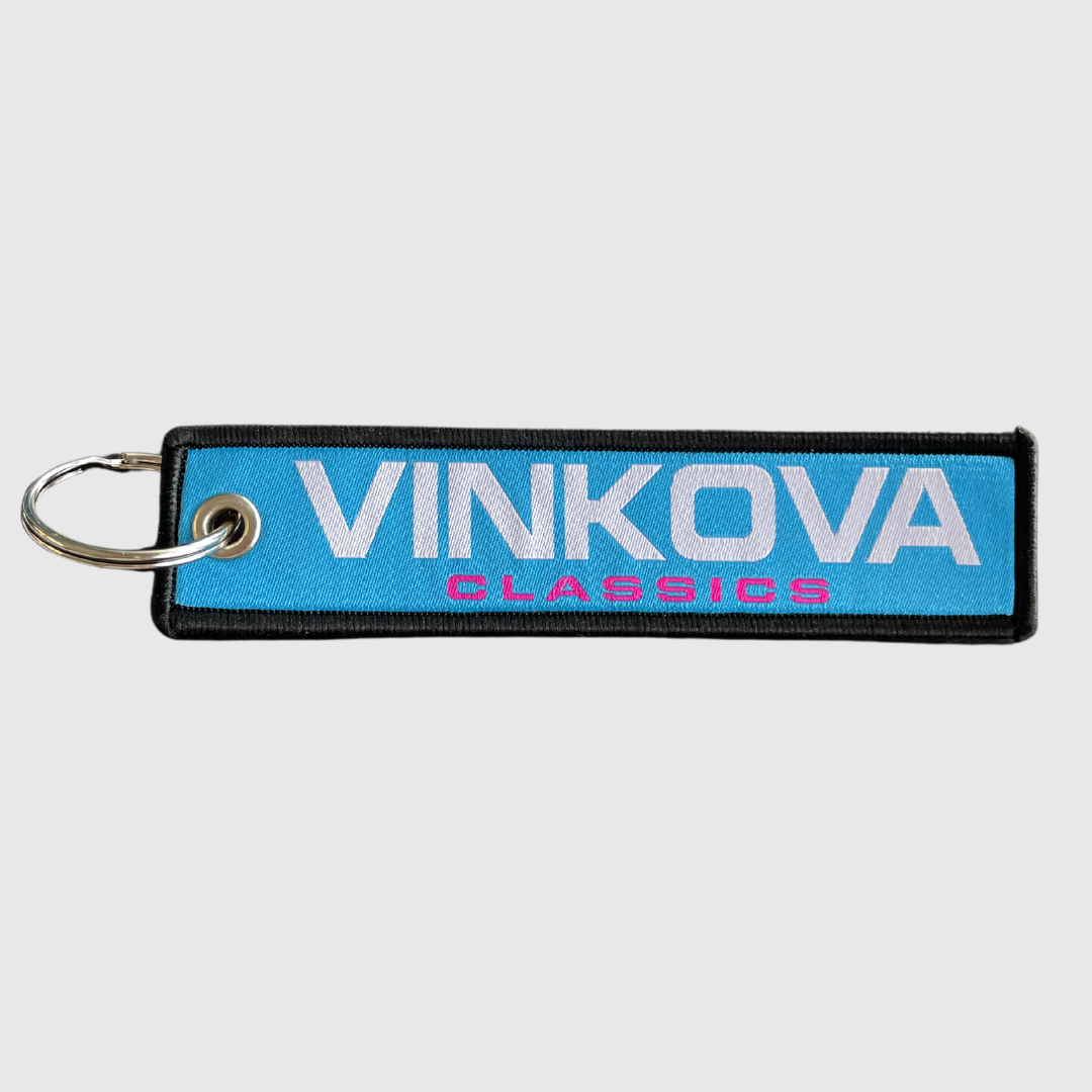 Portachiavi Vinkova, colore blu, con logo bianco e anello metallico.